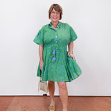Woman wearing a green dress with a white background