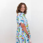 Woman wearing a colorful dress with a white background