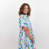 Woman wearing a colorful dress with a white background