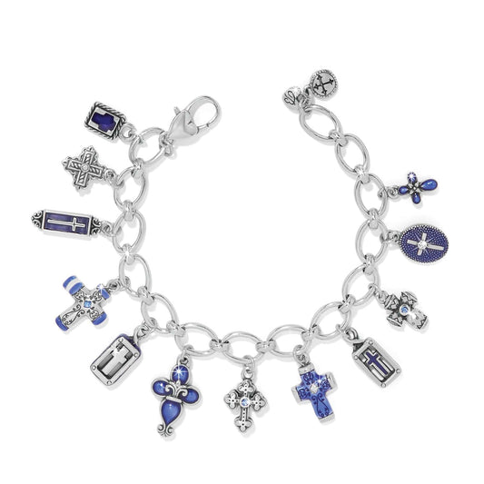 Silver charm bracelet with various charms on a white background