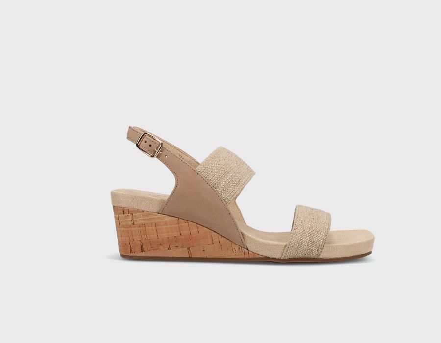 Beige wedge sandal with cork wedge sole on a light gray background