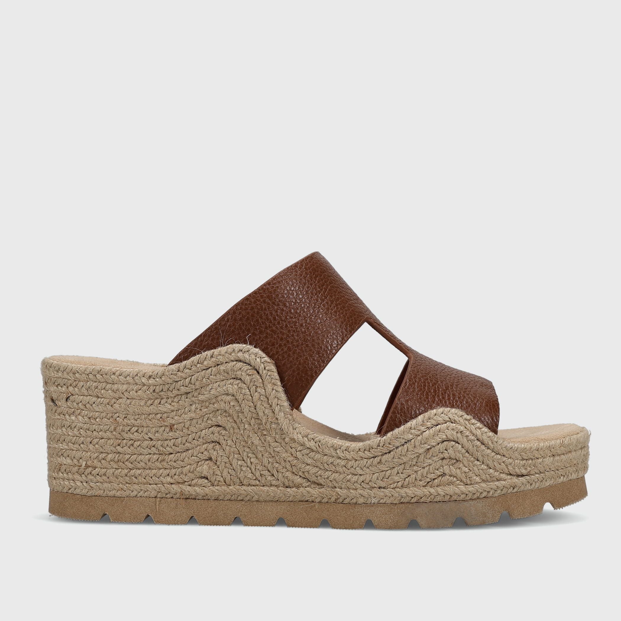 Brown sandal with jute sole on a light gray background