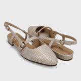 Pair of beige slingback shoes on a light gray background
