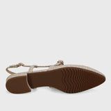 Flat sandal with brown sole on a light gray background