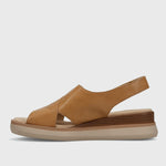 Brown sandal with a thick sole on a light gray background