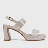 Silver glittery sandal with a block heel on a light gray background