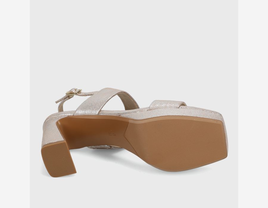 Beige sandal with a brown sole on a light gray background