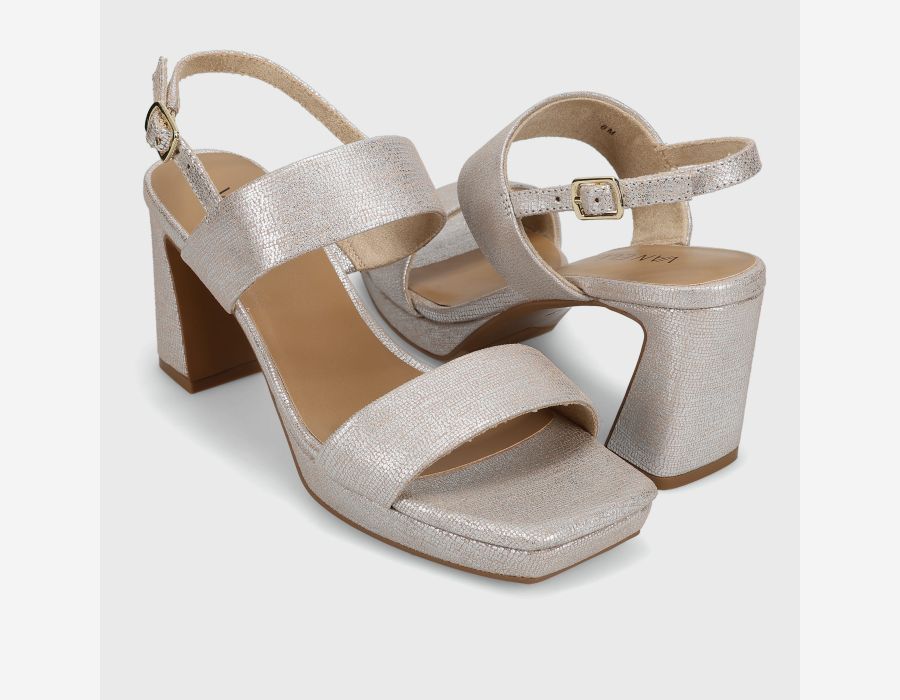 Pair of silver high-heeled sandals on a light gray background