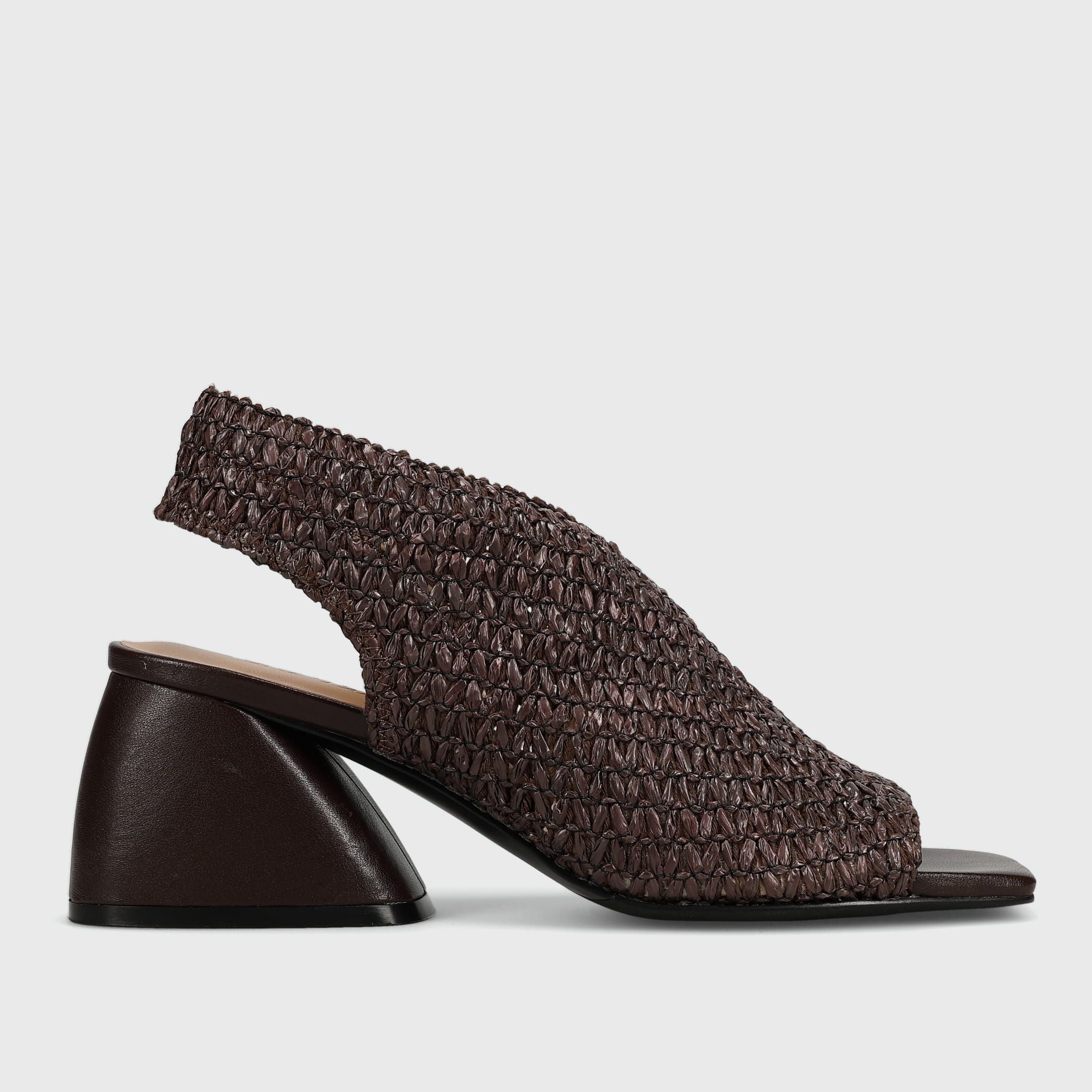 A single women's slingback sandal with a chunky block heel, featuring a dark brown woven upper and a smooth dark brown heel, shown from a side profile on a light gray background.