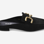 Black slip-on shoe with gold buckle detail on a white background
