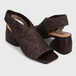 A pair of women's dark brown slingback block-heel sandals with a textured woven upper and open toe, shown on a light gray background.