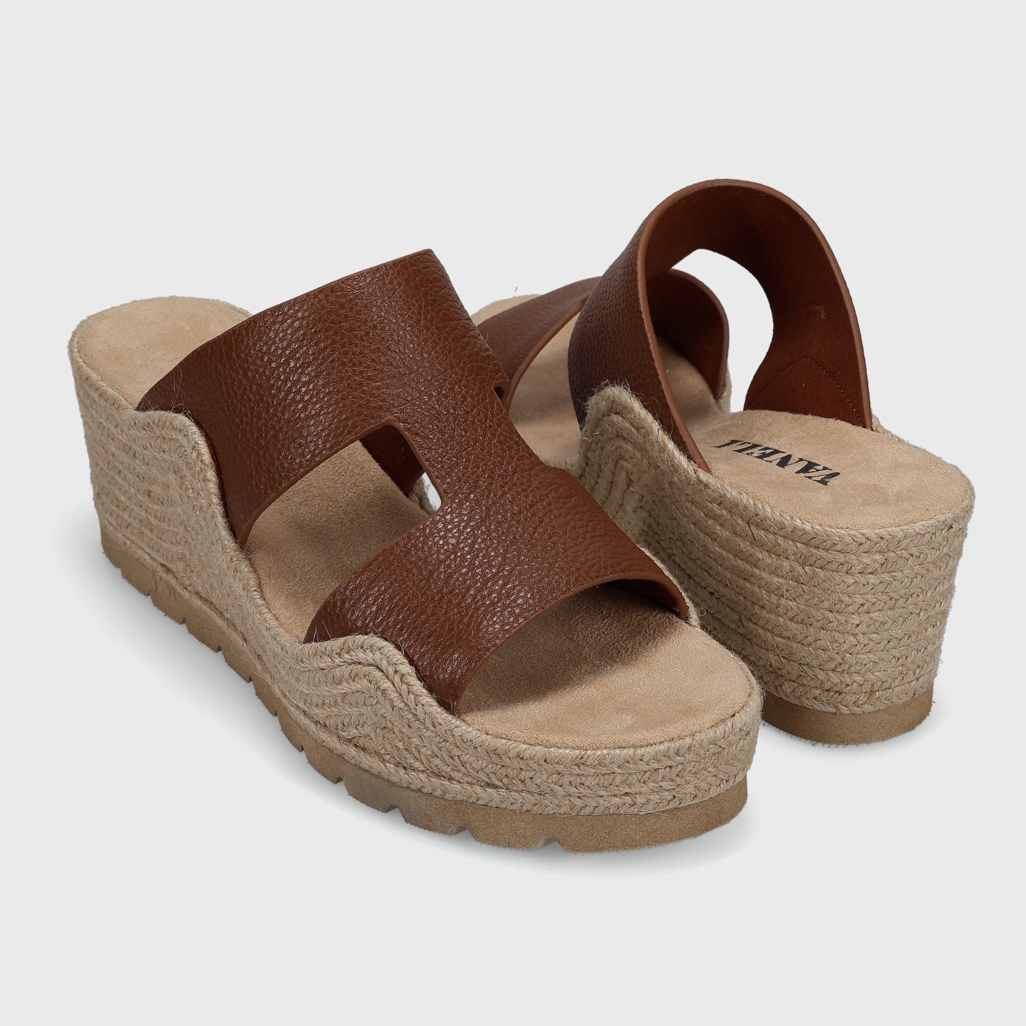 Brown sandals with jute sole on a light gray background
