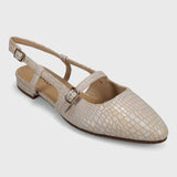 Beige flat shoe with slingback design on a light gray background