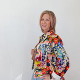 Woman wearing a colorful floral scarf against a white background