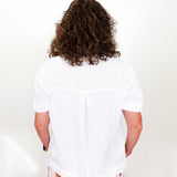 Person wearing a white shirt and colorful pants with a white background