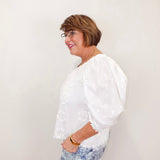 karen kane puff sleeve embroidered top in white styled with patterned denim