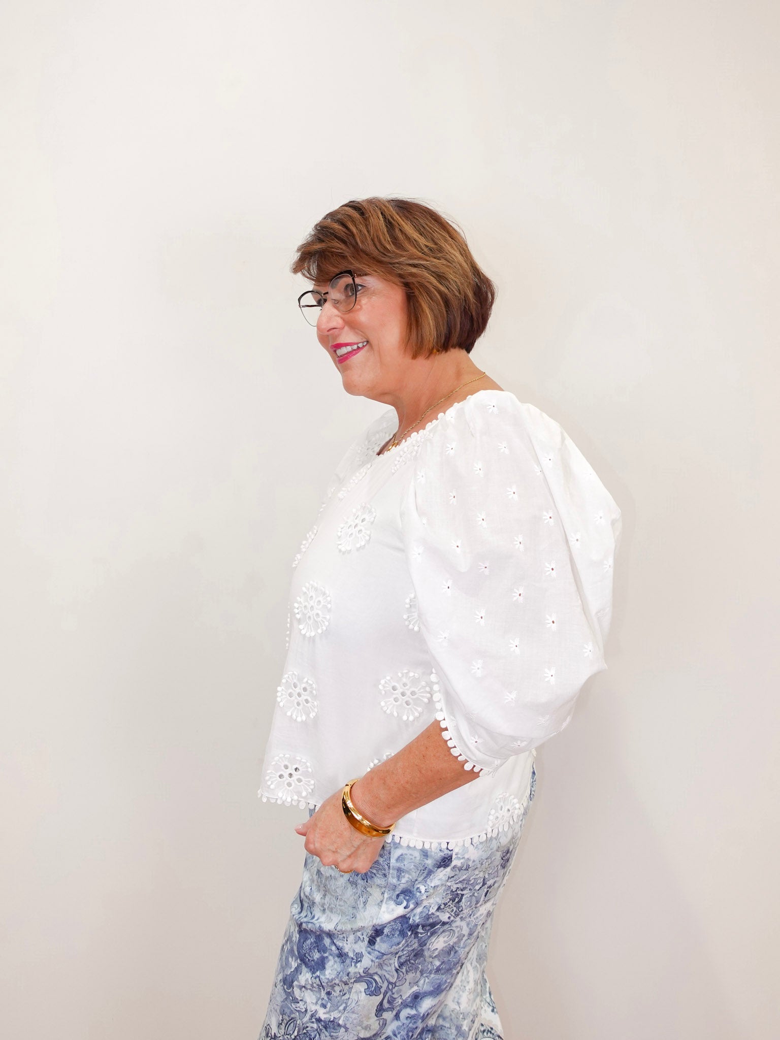 karen kane puff sleeve embroidered top in white styled with patterned denim