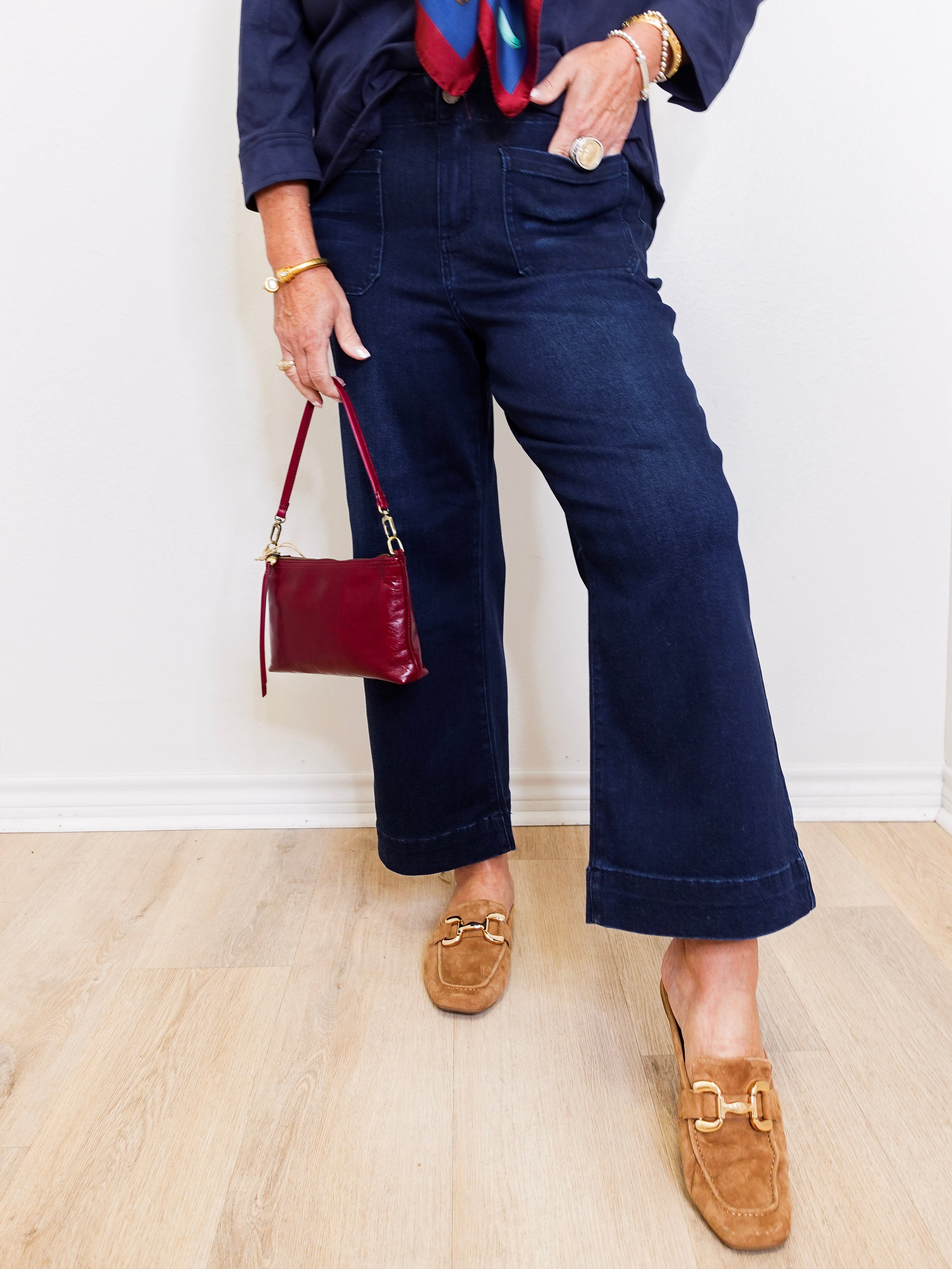 woman wearing a blue wide leg crop pant in front a white background.