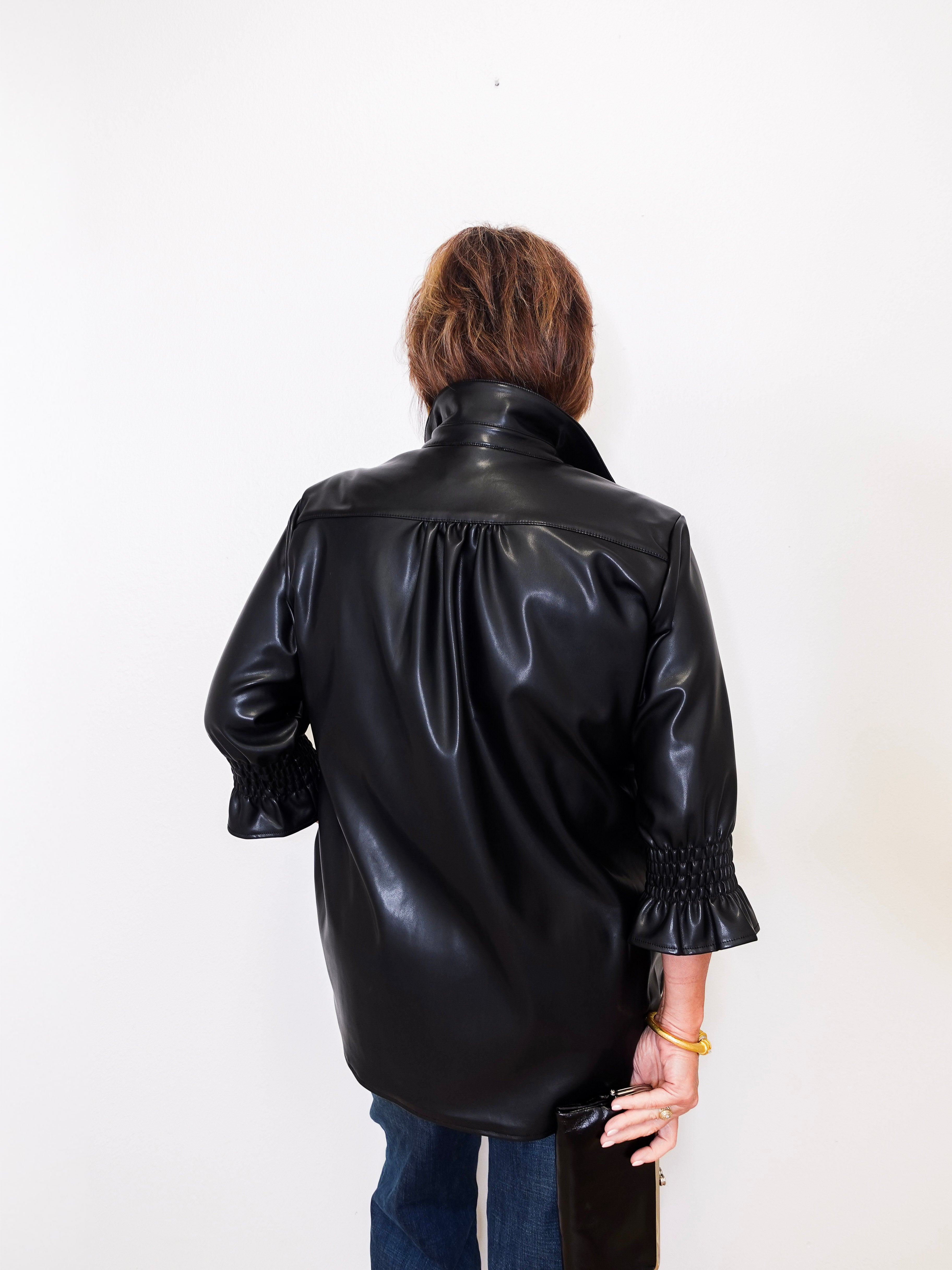 Person wearing a black leather jacket on a white background