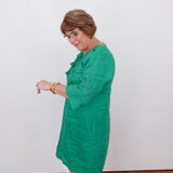 Woman wearing a green dress against a white background