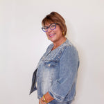 Woman wearing a denim jacket against a white background