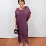 model wearing the helen silk kaftan long dress in eggplant with a flowy silhouette