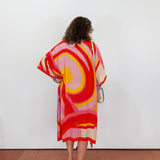Woman wearing a colorful dress with a white background