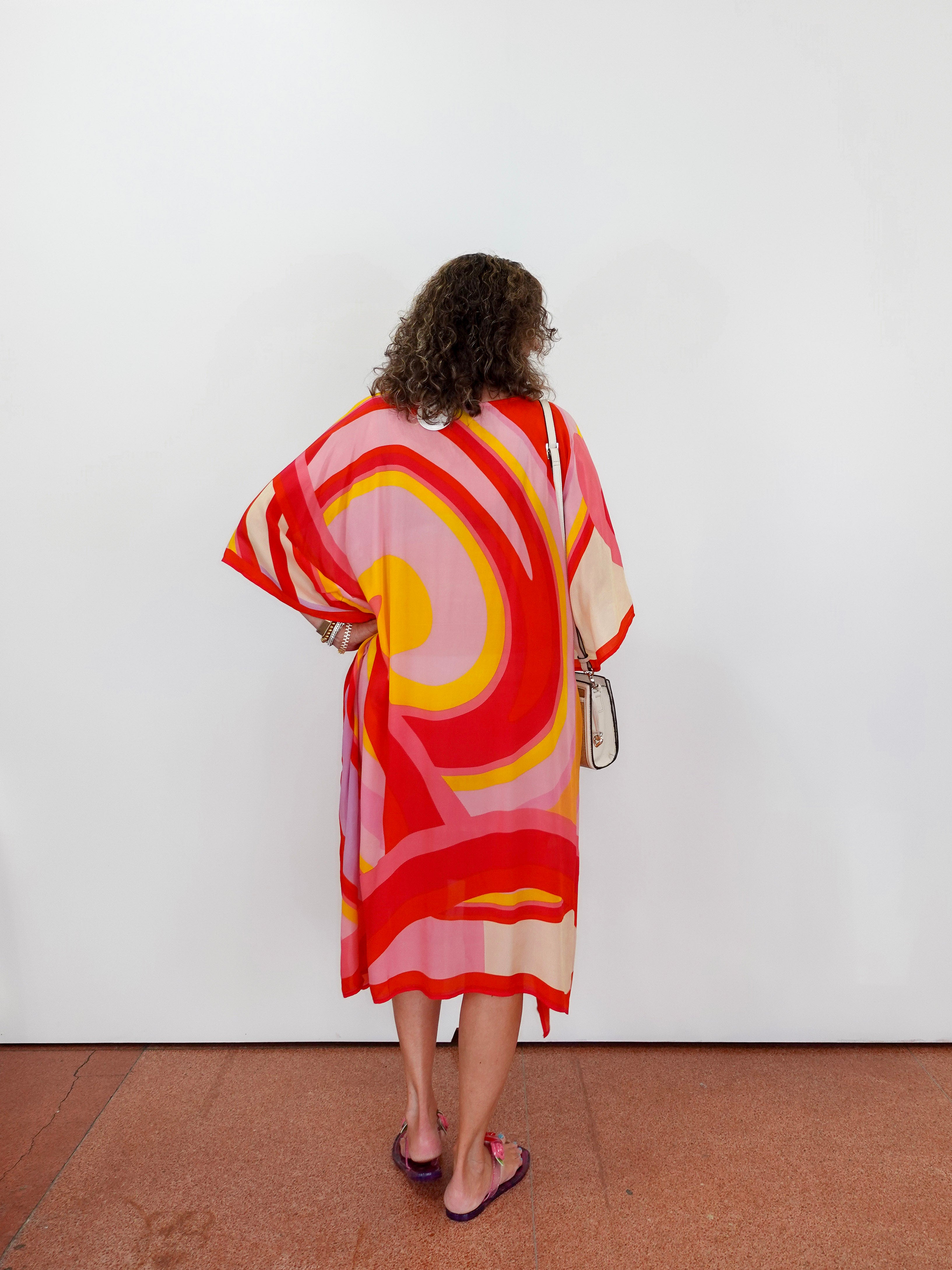 Woman wearing a colorful dress with a white background