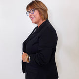 Woman wearing a black blazer against a white background