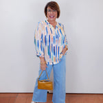 Woman wearing the Olivia wide ankle pant in pale blue with a relaxed, wide-leg fit.
