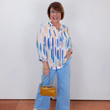 Woman wearing the Olivia wide ankle pant in pale blue with a relaxed, wide-leg fit.
