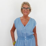 Woman wearing a light blue dress against a white background