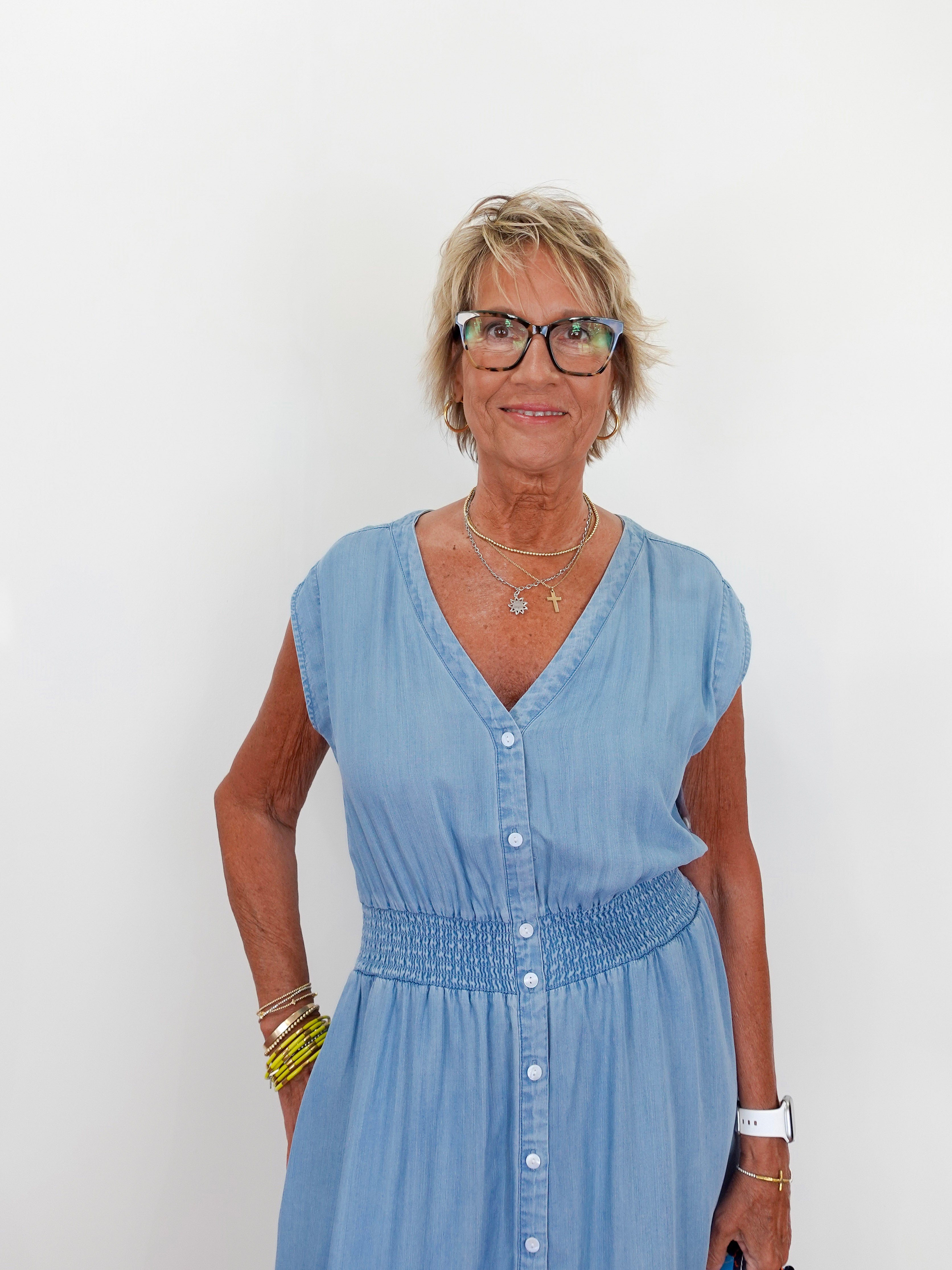 Woman wearing a light blue dress against a white background
