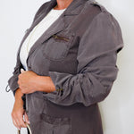 Woman wearing a gray jacket with a white background