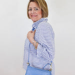 Woman holding a blue handbag against a white background