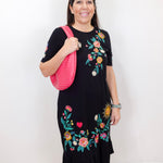 Model wearing the Zivana ruffle knit midi dress in black with colorful floral embroidery and ruffled hem.